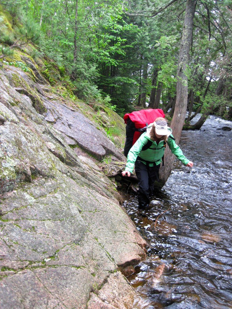 Kati tackles the Horsetail Rapids portage in high water on the Granite River 