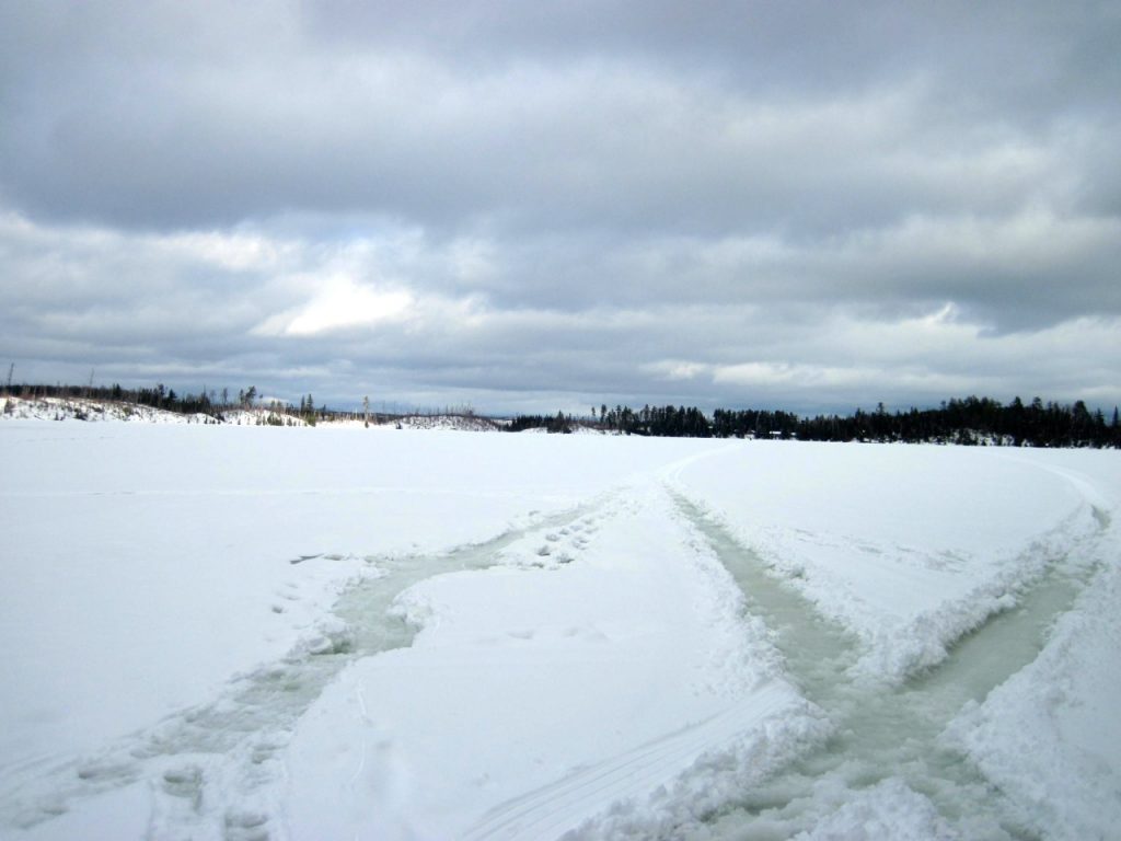 Slush Trails from winter campers and snowmobiles on Round Lake on the Gunflint Trail in MN